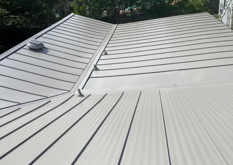 Solar attic fan installed on a metal roof for Roof Ventilation in Milford